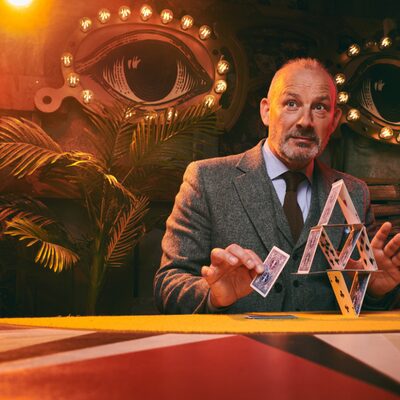 corporate magician performing close-up magic at a business event
